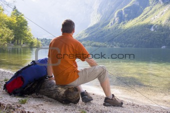 Hiker relaxing at a mountain lake