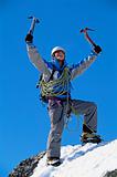 Young man celebrating on snowy peak