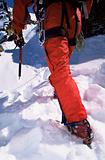 Close-up of young man mountain climbing on snowy peak