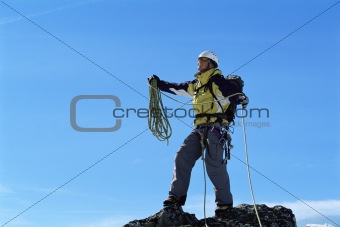 Mountaineer on top of mountain summit