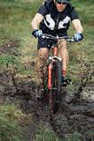 Mountain biker crossing mud