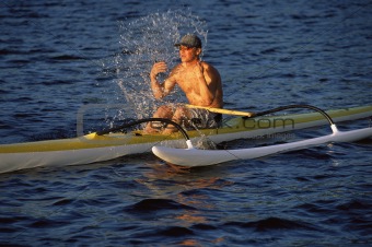 Man refreshing while canoeing