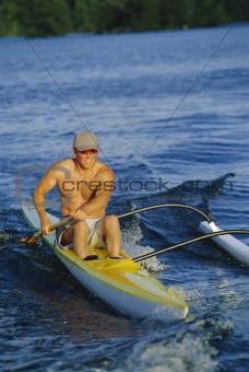 Man canoeing at sunset