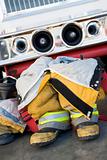 Empty firefighter's boots and uniform next to fire engine