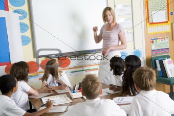 A teacher teaching a junior school class