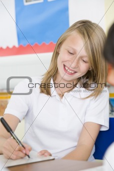 A schoolgirl studying in class