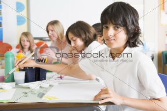Schoolchildren and their teacher in an art class