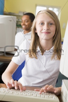 Schoolgirl studying in front of a school computer