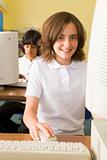 Schoolgirl studying in front of a school computer