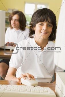 Schoolboy studying in front of a school computer