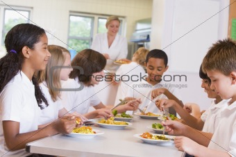Schoolchildren enjoying their lunch in a school cafeteria