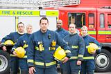 Portrait of a group of firefighters by a fire engine