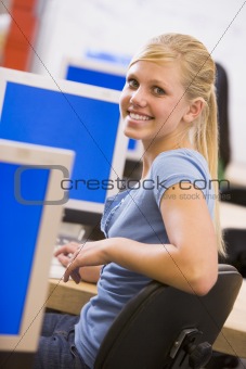 Schoolgirl sitting in front of a computer in a high school class