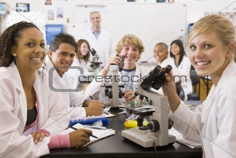 School children and their teacher in a high school science class