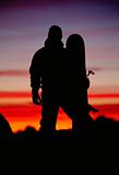 Silhouette of  snowboarder against sunset