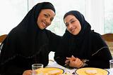 Two Middle Eastern women enjoying a meal 