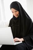 A middle eastern woman using a laptop