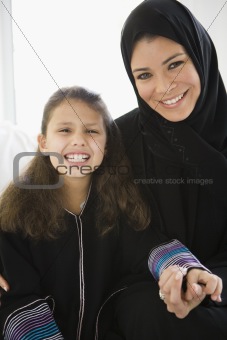A Middle Eastern woman with her daughter