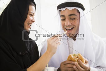 A Middle Eastern couple sharing a fast food meal