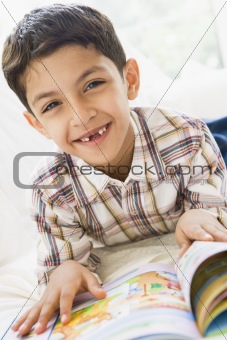A Middle Eastern boy reading a book