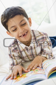 A Middle Eastern boy reading a book
