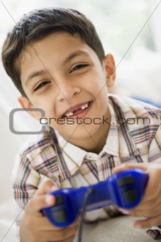 A Middle Eastern boy playing a video game