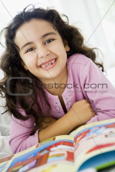 A Middle Eastern girl reading a book