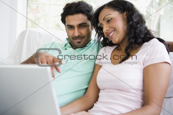 A Middle Eastern couple sitting with a laptop