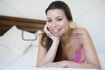A Middle Eastern woman lying on a bed