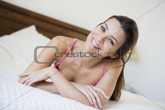A Middle Eastern woman lying on a bed