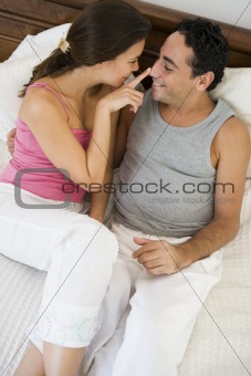 A Middle Eastern couple lying on a bed