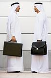 Two Middle Eastern businessmen holding briefcases