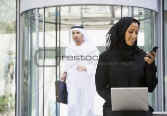 A Middle Eastern business woman sitting with a laptop