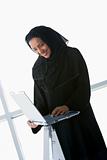 A Middle Eastern businesswoman using a laptop