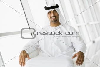 A Middle Eastern businessman sitting in a chair