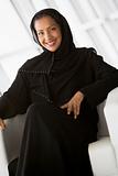 A Middle Eastern businesswoman sitting in a chair