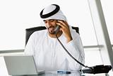 A Middle Eastern businessman talking on the telephone