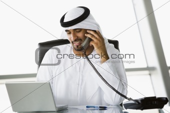 A Middle Eastern businessman talking on the telephone
