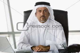 A Middle Eastern businessman using a laptop