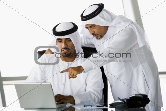 Two Middle Eastern businessmen looking at a computer