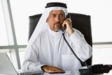 A Middle Eastern businessman talking on the phone