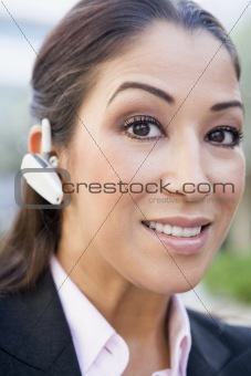 Businesswoman using bluetooth earpiece