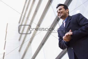 Businessman standing outside office building
