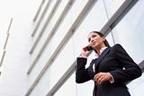 Businesswoman talking on cell phone outside