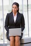 Businesswoman using laptop outside