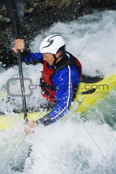 Man kayaking in rapids