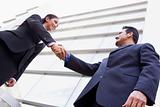 Business people shaking hands outside office