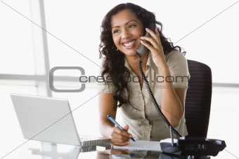 Businesswoman taking telephone call