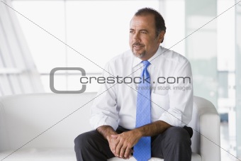 Businessman sitting on sofa in lobby