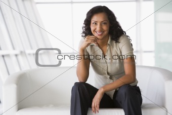 Businesswoman sitting on sofa in lobby